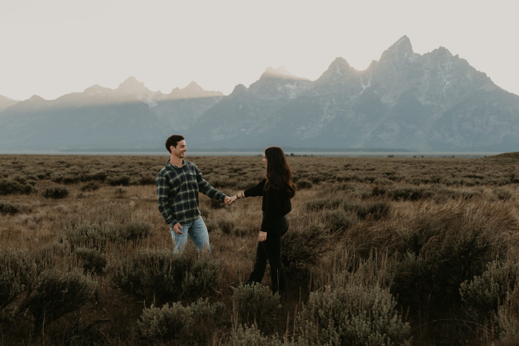 Couple walks together holding hands in Jackson Hole